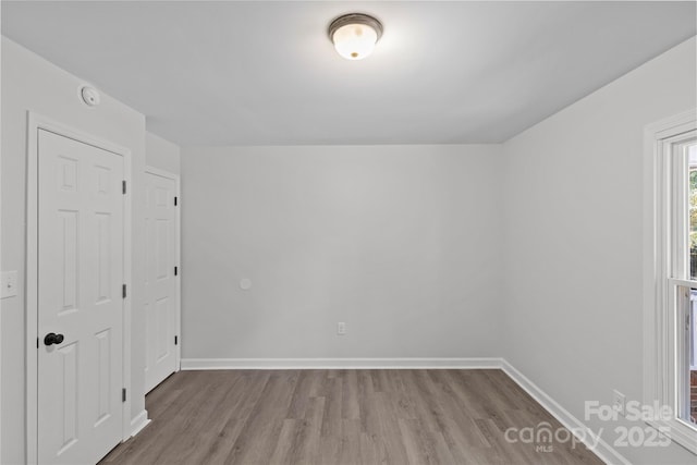 unfurnished room featuring light wood-type flooring