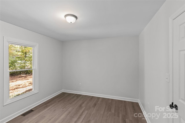 empty room with hardwood / wood-style flooring