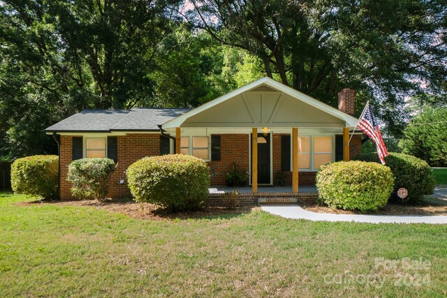 view of front of house with a porch and a front lawn