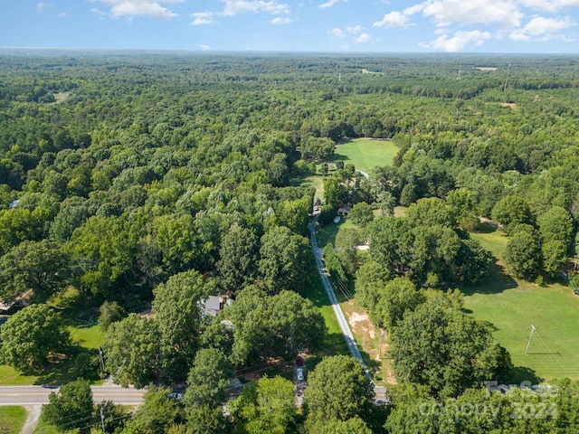 bird's eye view with a wooded view