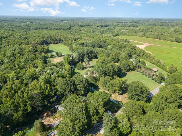 birds eye view of property featuring a view of trees