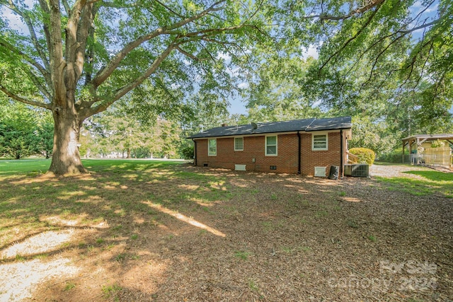 view of yard with fence and central AC