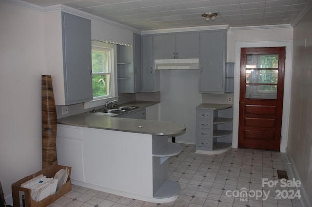 kitchen with sink, ornamental molding, light tile patterned floors, and gray cabinets