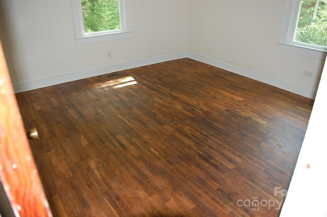 empty room featuring dark hardwood / wood-style flooring