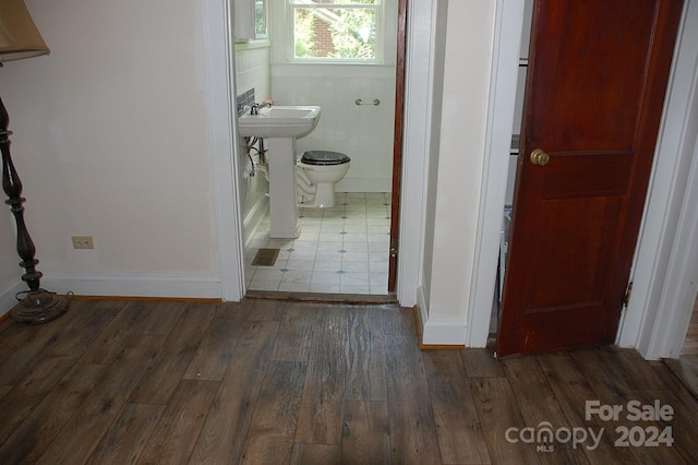 bathroom with hardwood / wood-style flooring, sink, and toilet