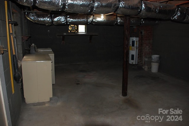 basement with independent washer and dryer, brick wall, and water heater