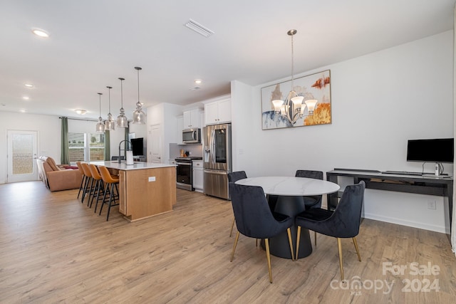 dining room featuring recessed lighting, light wood-type flooring, visible vents, and a notable chandelier