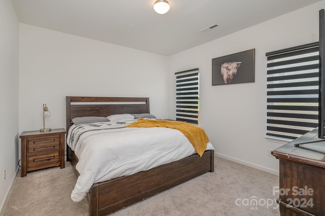 bedroom with carpet flooring, visible vents, and baseboards