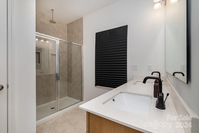 bathroom featuring a stall shower, a sink, and double vanity