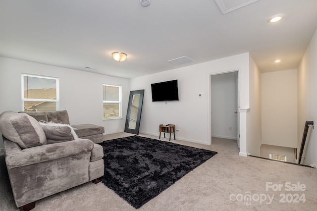 carpeted living area with baseboards, visible vents, and recessed lighting