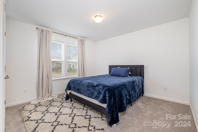 carpeted bedroom featuring baseboards