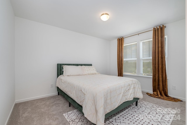 bedroom featuring carpet floors and baseboards