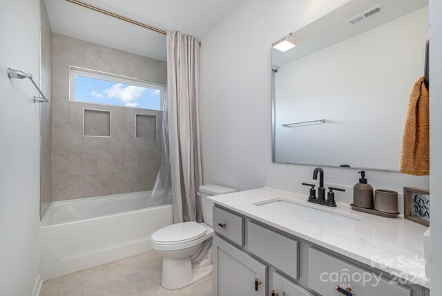 full bath with shower / tub combo, visible vents, toilet, tile patterned floors, and vanity