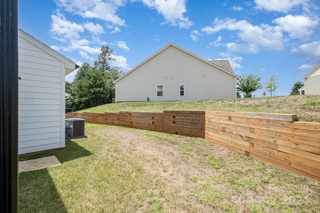 view of yard featuring fence and central AC unit