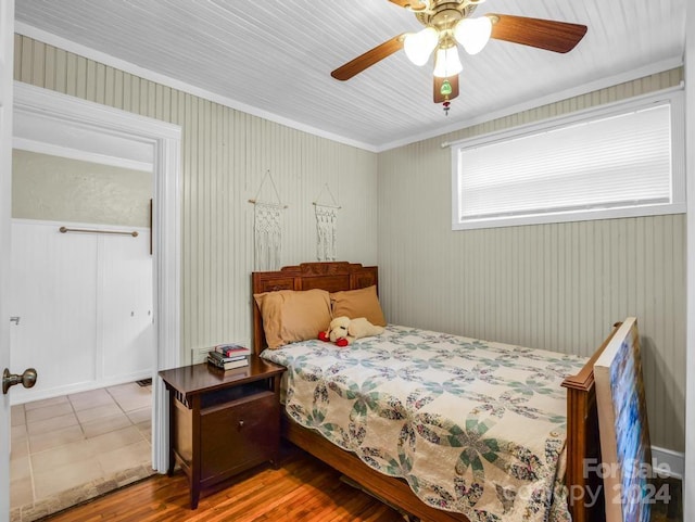 tiled bedroom with a ceiling fan