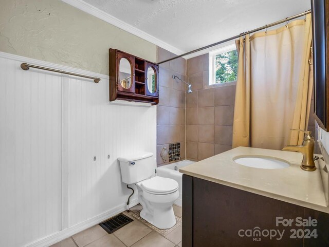 bathroom with visible vents, toilet, a textured ceiling, vanity, and tile patterned flooring