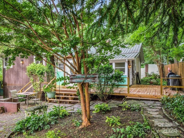 view of yard featuring fence and a wooden deck