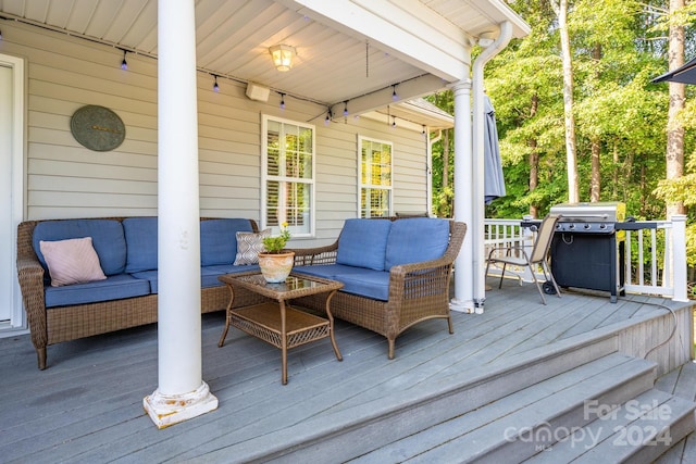 deck with an outdoor living space and grilling area