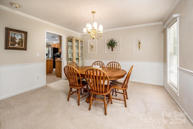 dining room featuring crown molding, an inviting chandelier, light carpet, and a textured ceiling