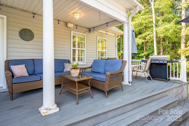 deck featuring area for grilling and an outdoor living space