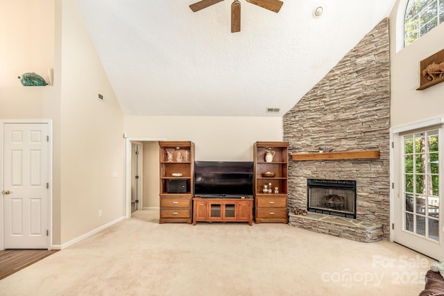 living area with a fireplace, baseboards, carpet floors, and visible vents