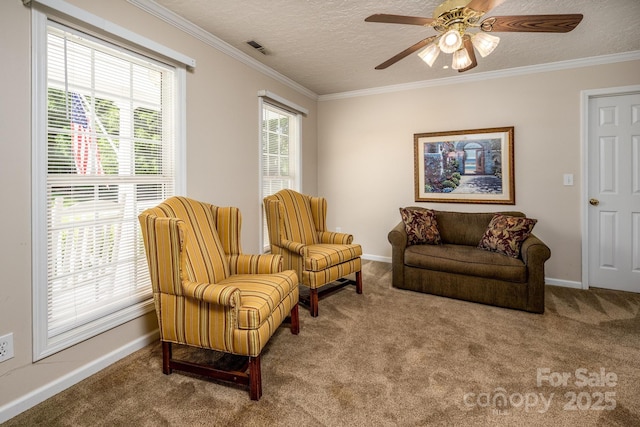 sitting room featuring baseboards, visible vents, carpet flooring, ornamental molding, and a textured ceiling