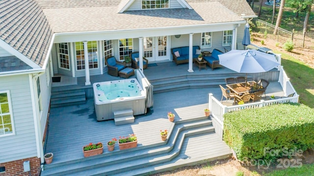 wooden terrace featuring a hot tub, outdoor lounge area, and french doors