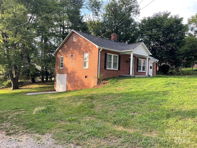 view of home's exterior with a yard