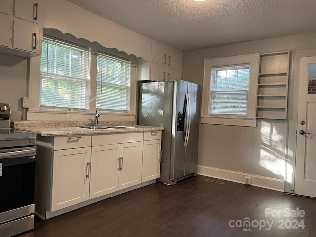 kitchen with a textured ceiling, white cabinetry, dark hardwood / wood-style flooring, stainless steel appliances, and sink