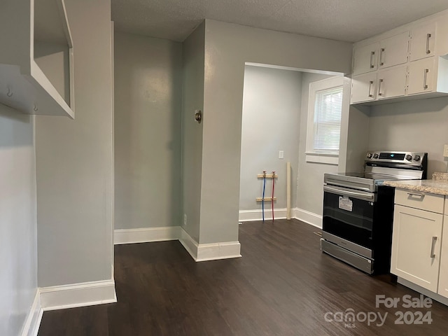 kitchen with a textured ceiling, white cabinets, dark hardwood / wood-style floors, and stainless steel electric range oven