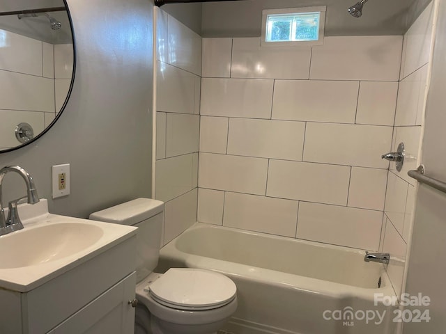 full bathroom featuring toilet, vanity, and tiled shower / bath