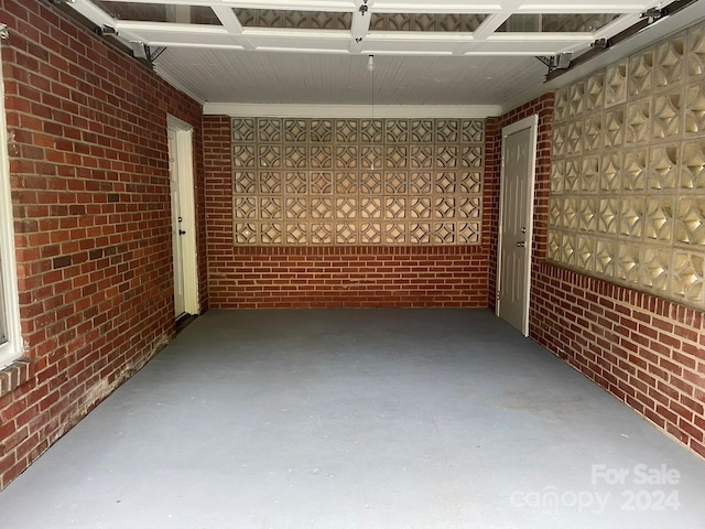 basement featuring brick wall