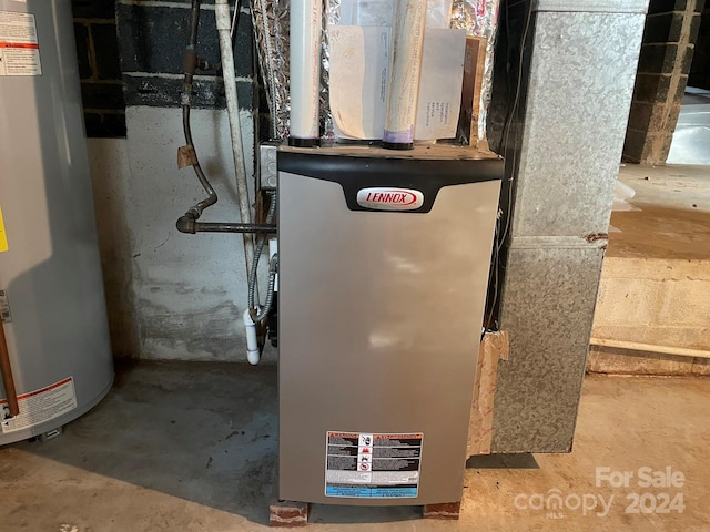 utility room featuring water heater