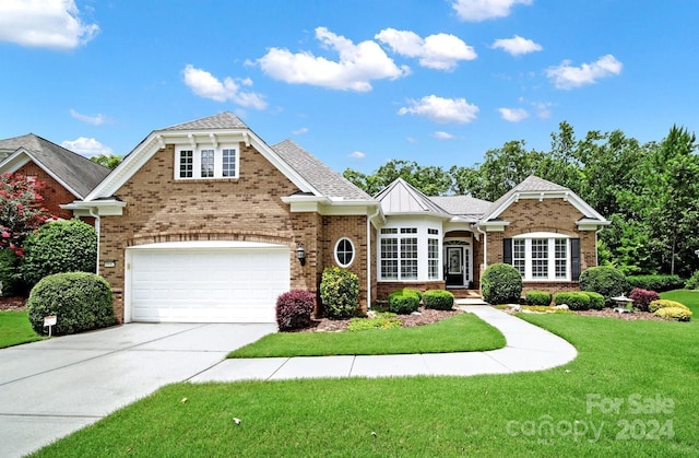 view of front facade featuring a garage and a front lawn