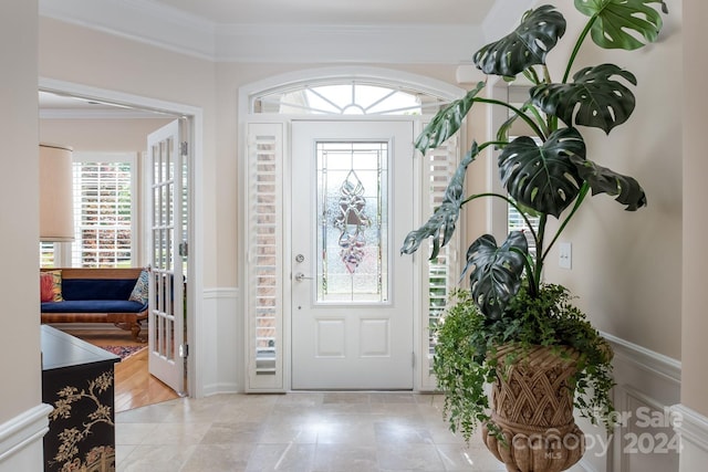 entryway featuring crown molding