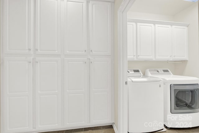 laundry room featuring cabinet space and washing machine and dryer