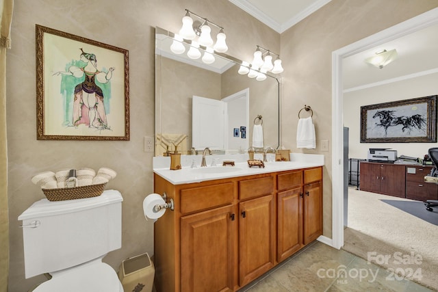 bathroom featuring crown molding, a sink, toilet, and double vanity