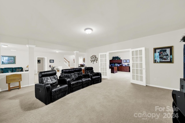 carpeted cinema featuring ornate columns, baseboards, and french doors