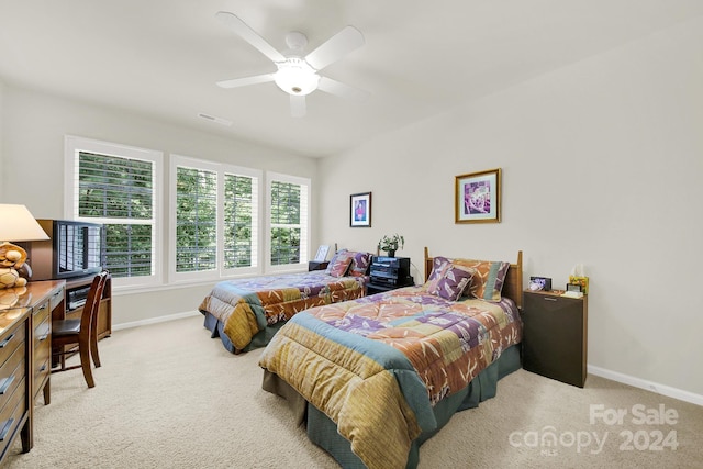 bedroom with light carpet and ceiling fan