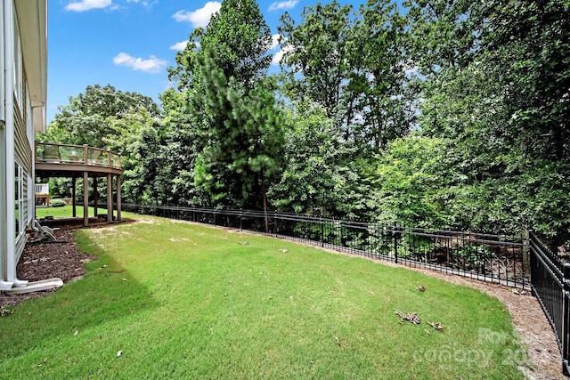 view of yard with fence and a wooden deck