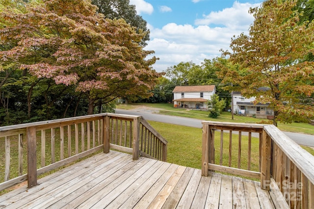 wooden deck with a lawn