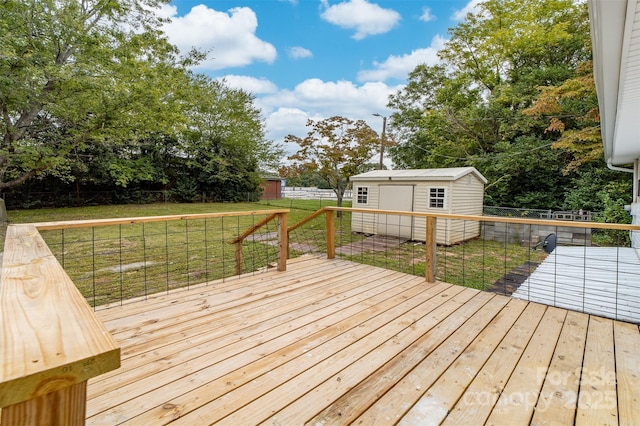 wooden terrace featuring a yard and a shed