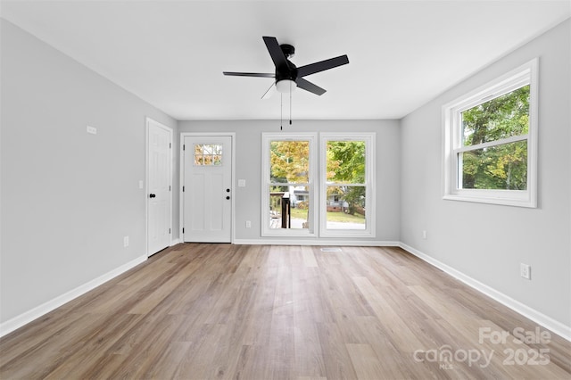 unfurnished room with light wood-type flooring and ceiling fan