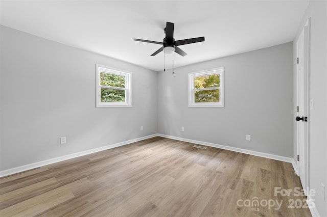 unfurnished room with light hardwood / wood-style flooring and ceiling fan