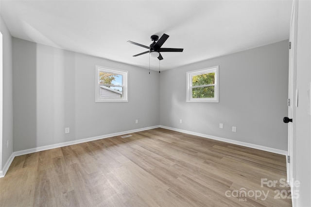 empty room featuring ceiling fan and light wood-type flooring