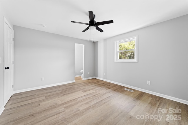 spare room with light hardwood / wood-style floors and ceiling fan