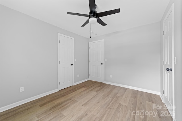 unfurnished bedroom featuring ceiling fan and light hardwood / wood-style floors