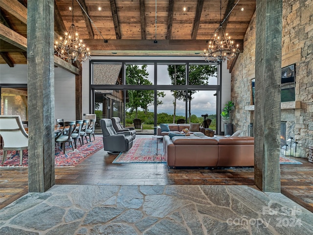 living room featuring a notable chandelier, beamed ceiling, wooden ceiling, and high vaulted ceiling