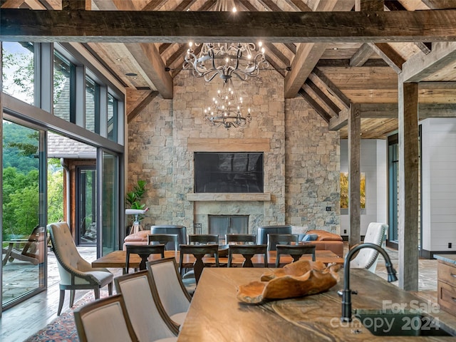 interior space with beam ceiling, plenty of natural light, and an inviting chandelier