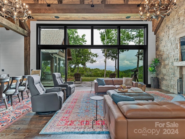 living room featuring wood-type flooring, a chandelier, and a fireplace